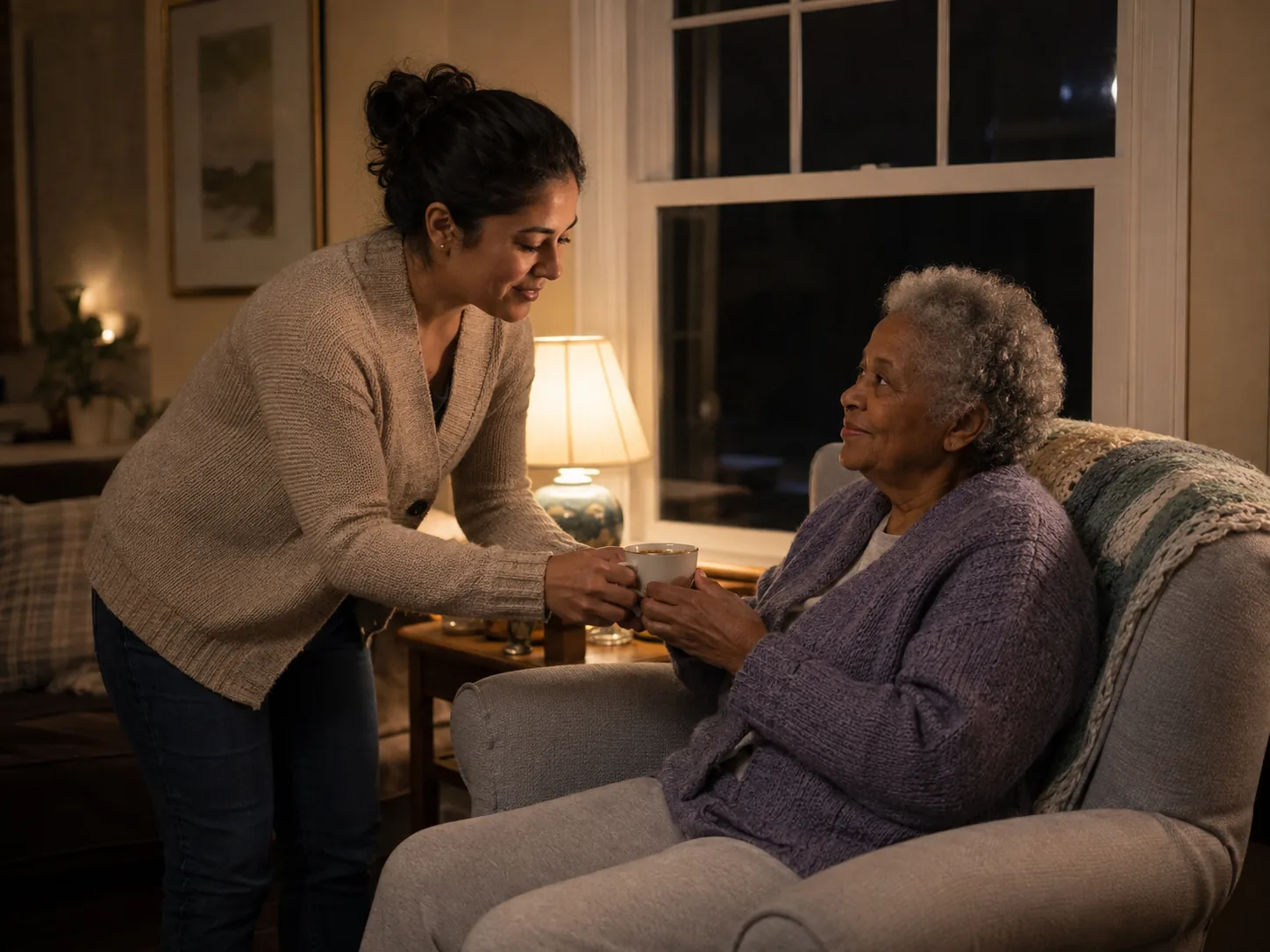 24-hour home care service: caregiver bringing a drink to an elderly woman late at night